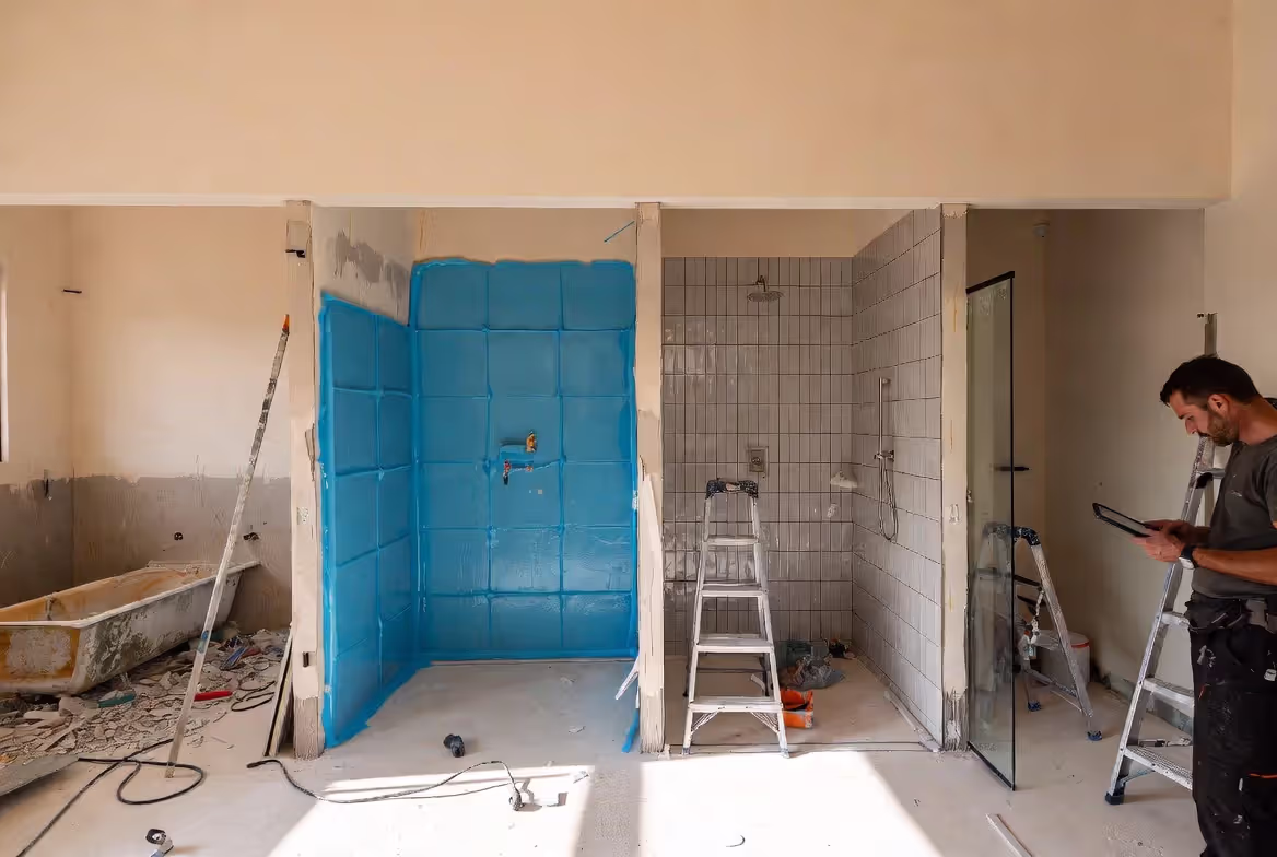 Bathtub to shower conversion shown through key renovation stages