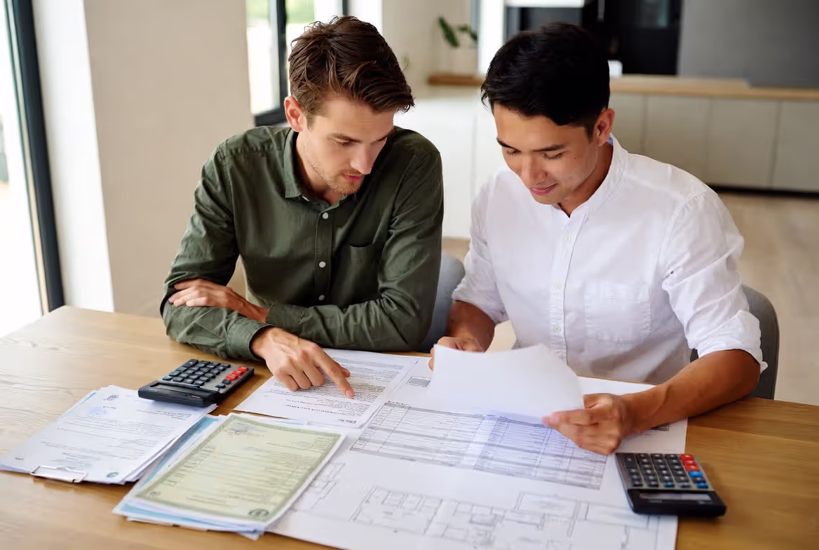 Homeowners comparing contractor credentials and bids