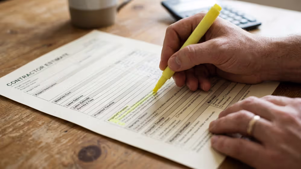 Homeowner reviewing detailed renovation estimate with labor, materials, permits, and timeline
